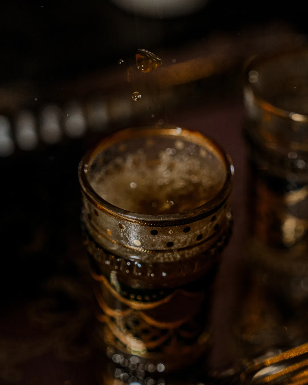Mid-air · drops caught over the glass