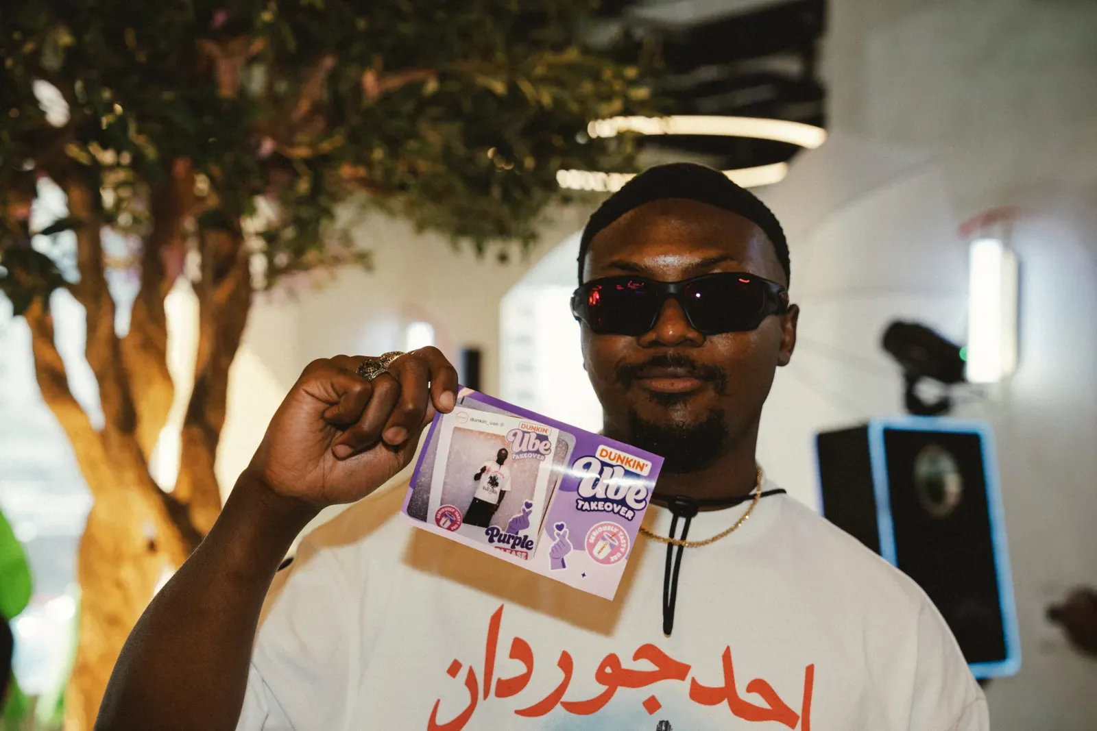 Guest holding his UBE Takeover print